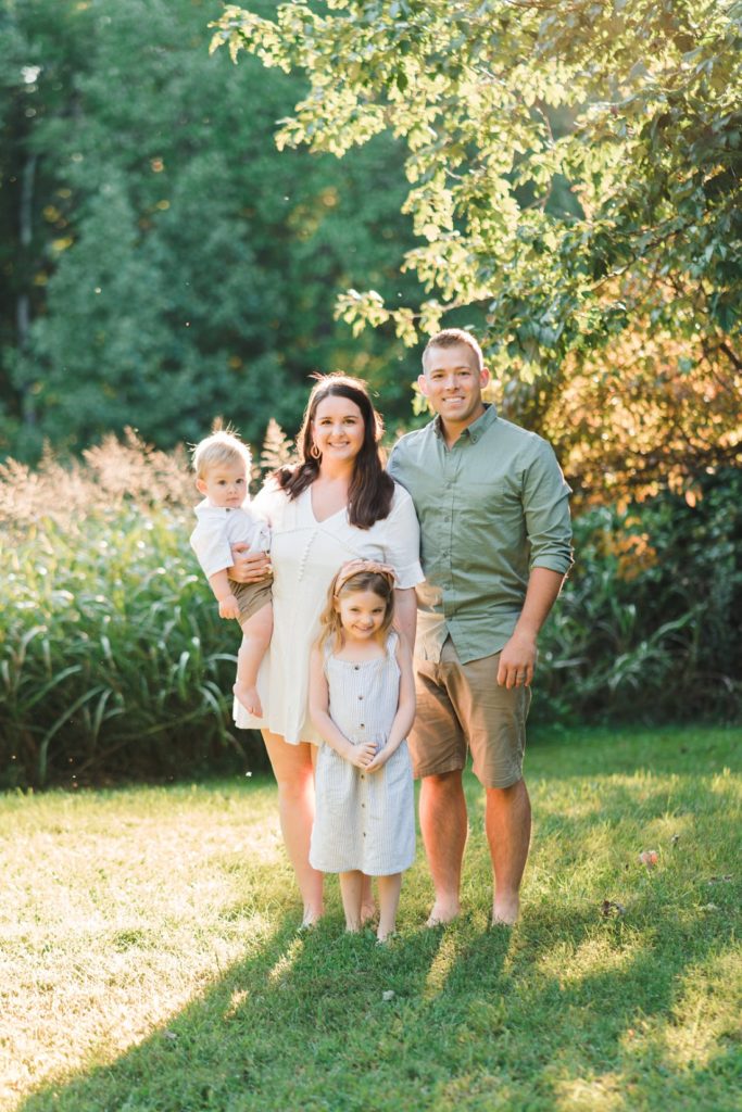 Family of four standing in grass in sunlight Family Photographers Montgomery Alabama | Melissa Sheridan Photography