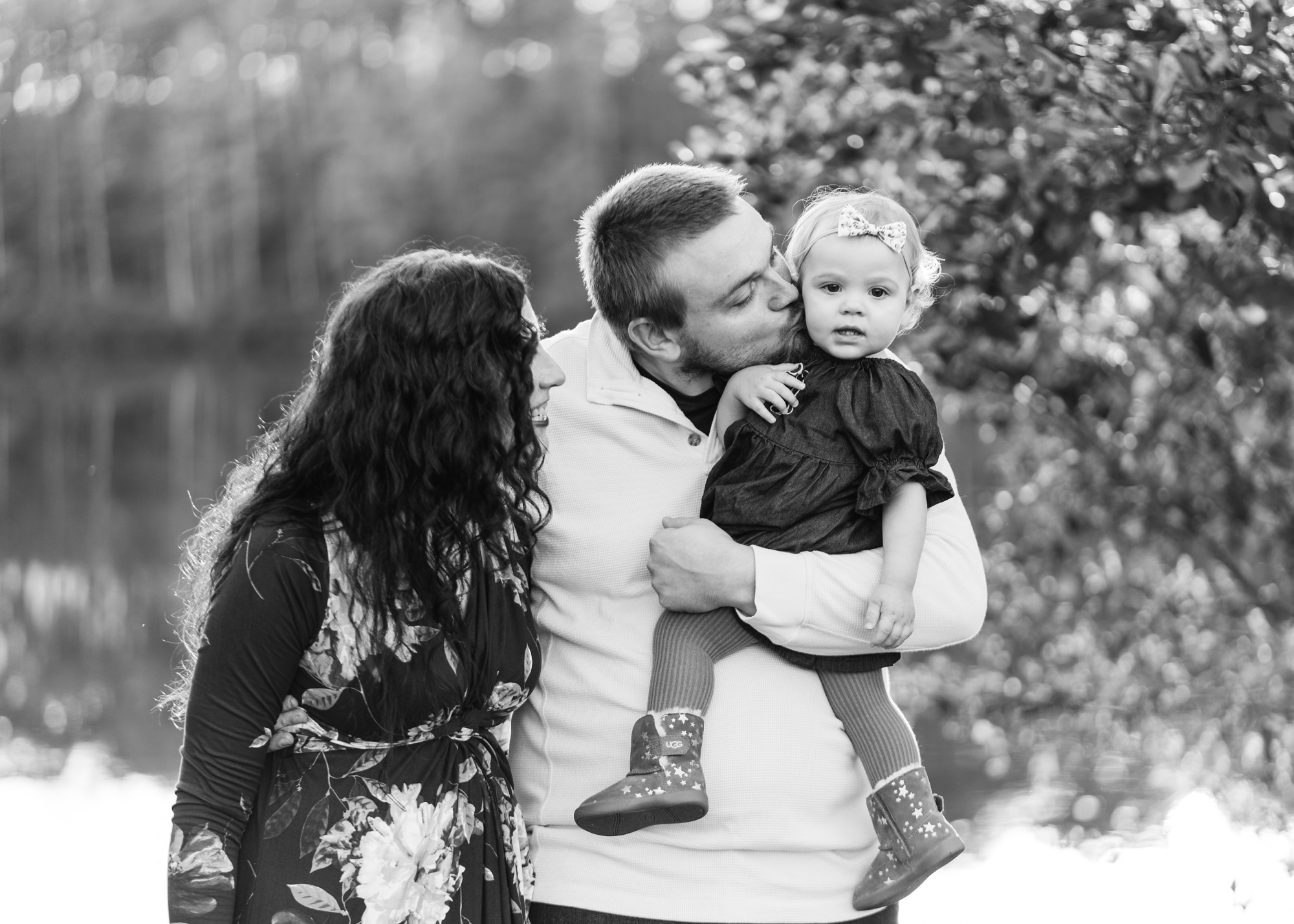 dad kissing baby girl with mom | Photographers in Charlottesville