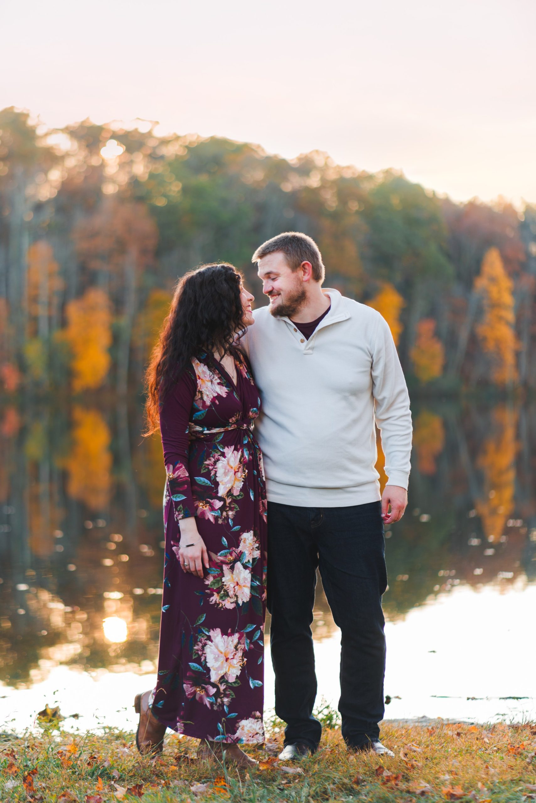 couple standing in front of pond with trees | Photographers in Charlottesville