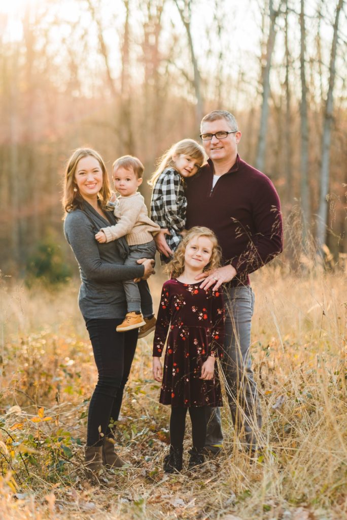 Family of 5 standing in field at golden hour | Family Photographer