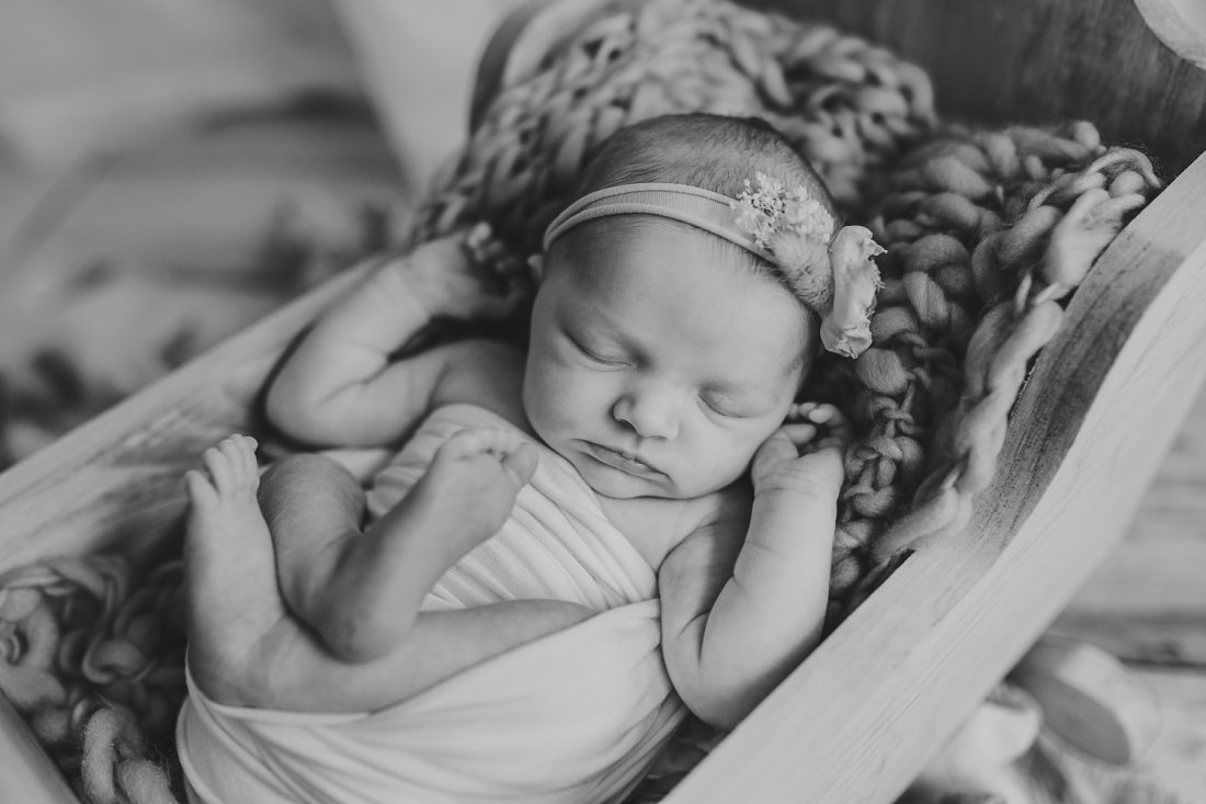 Black and white image of baby in cradle | Dayton Newborn Photography