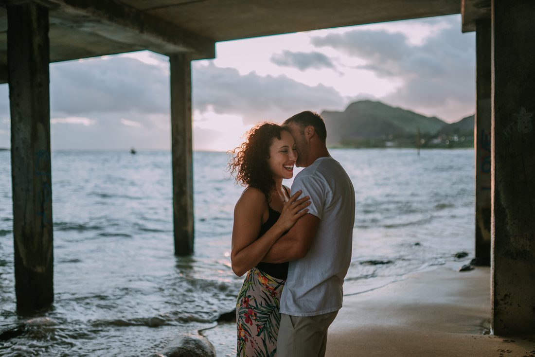 man kissing woman's neck on beach |  beach engagement photos