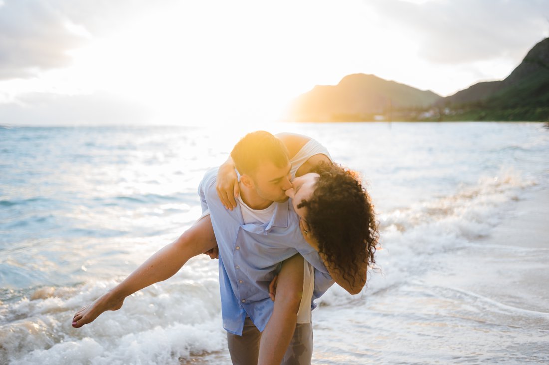 man and woman kissing on beach | beach engagement photos