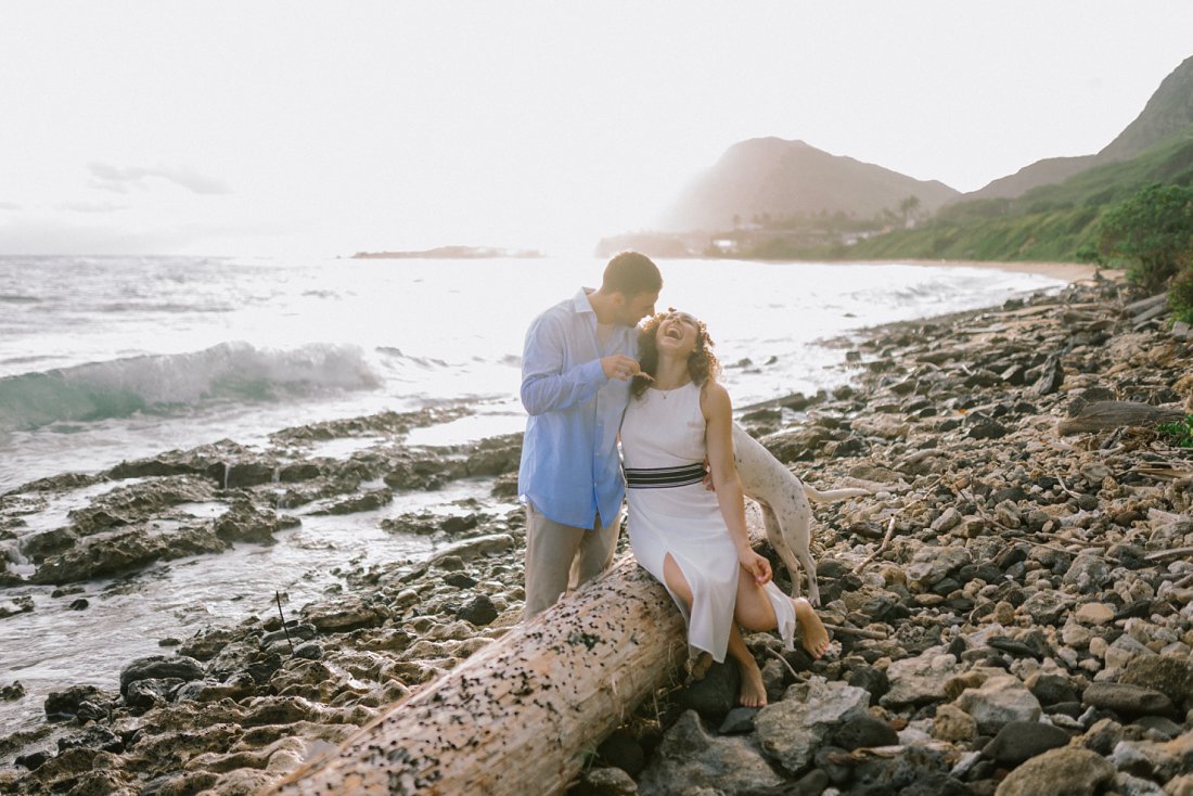 man holding crab with woman on beach | beach engagement photos