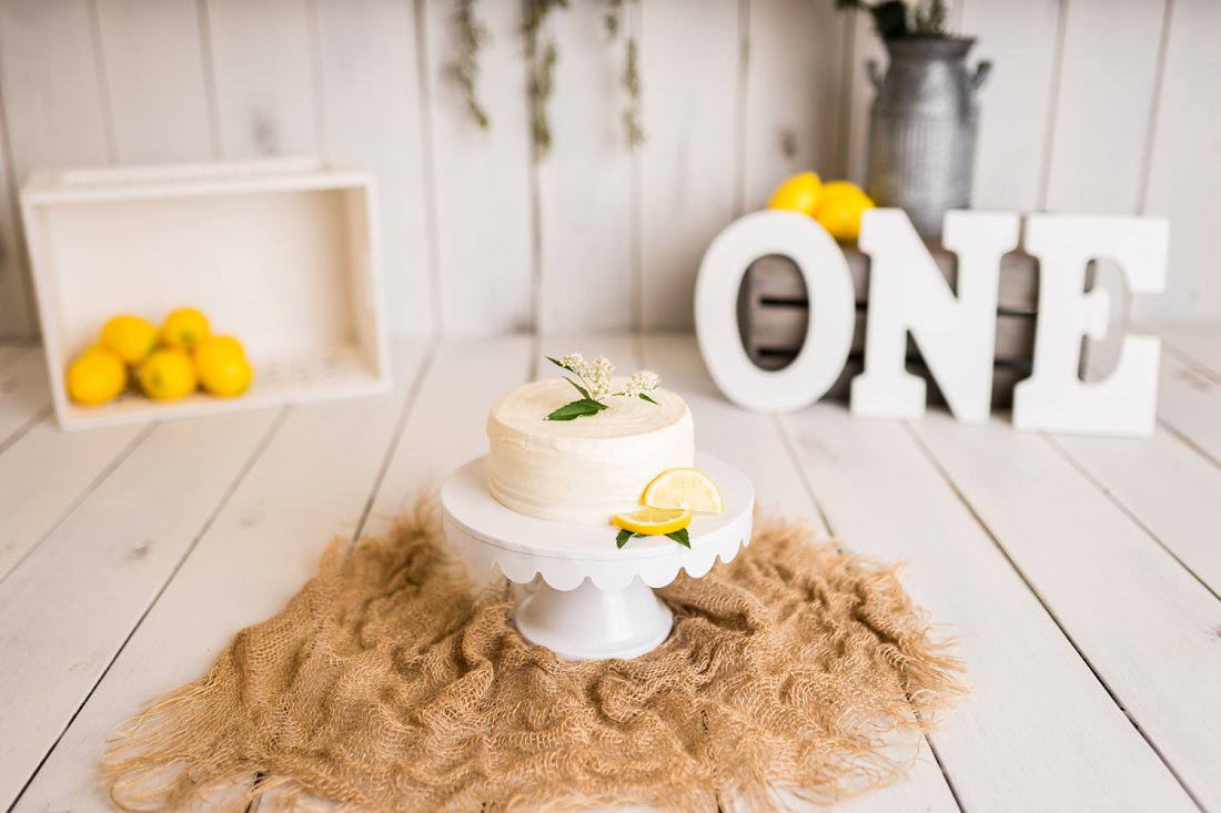 Small white cake on cake stand with lemons | Melissa Sheridan Phototgraphy