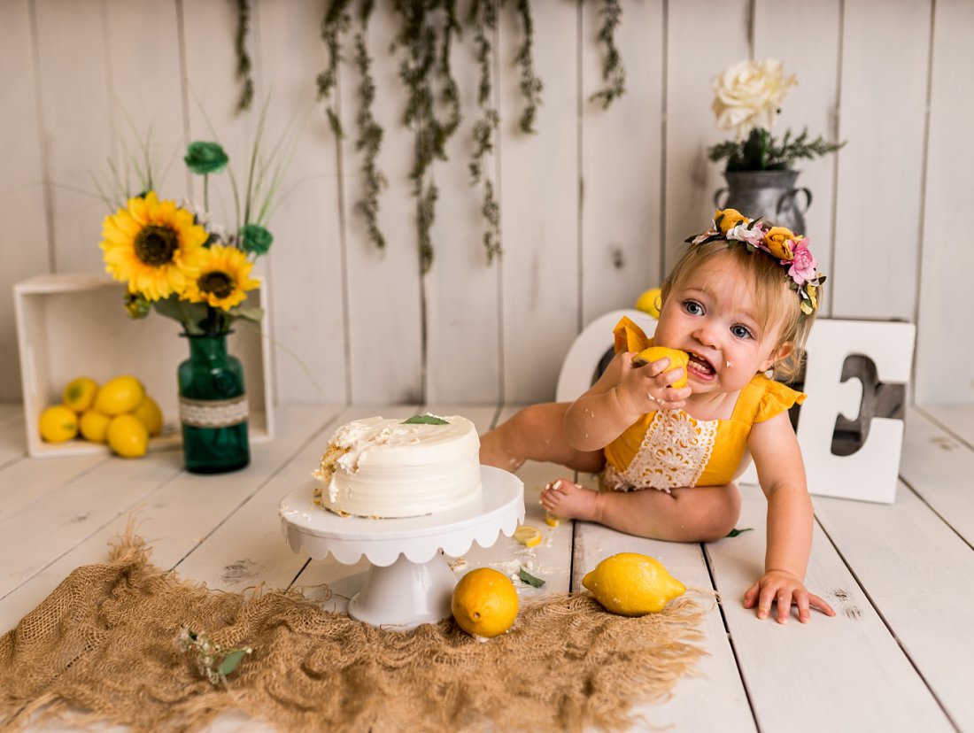 baby eating lemon next to cake | Dayton Photographer