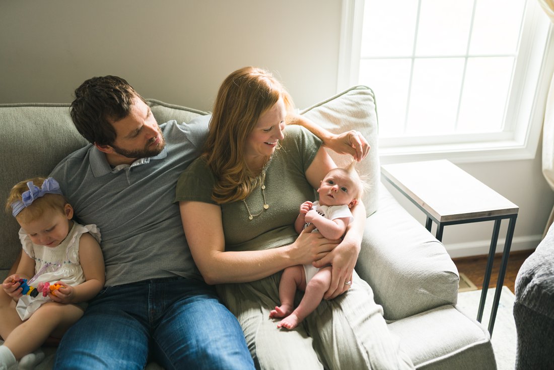 family of four sitting on couch | Montgomery Alabama newborn lifestyle photographer