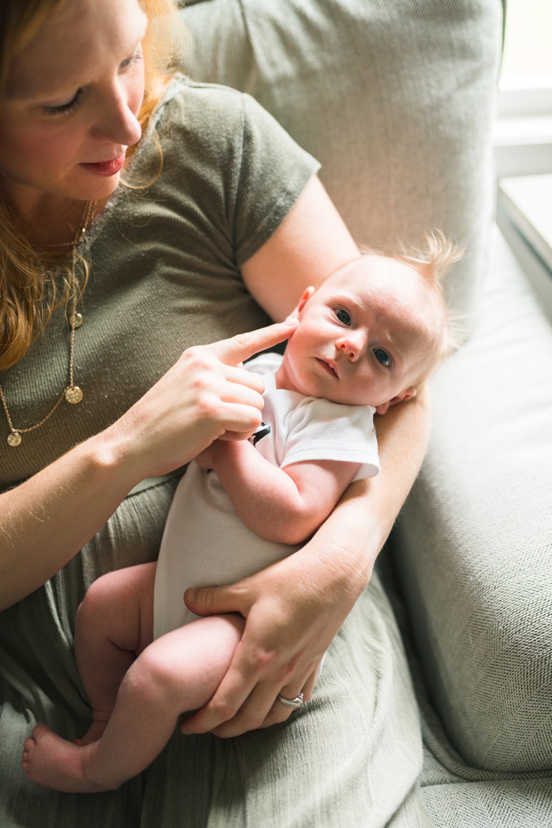 mom touching baby girls cheek | Dayton Ohio Newborn Lifestyle Photographer
