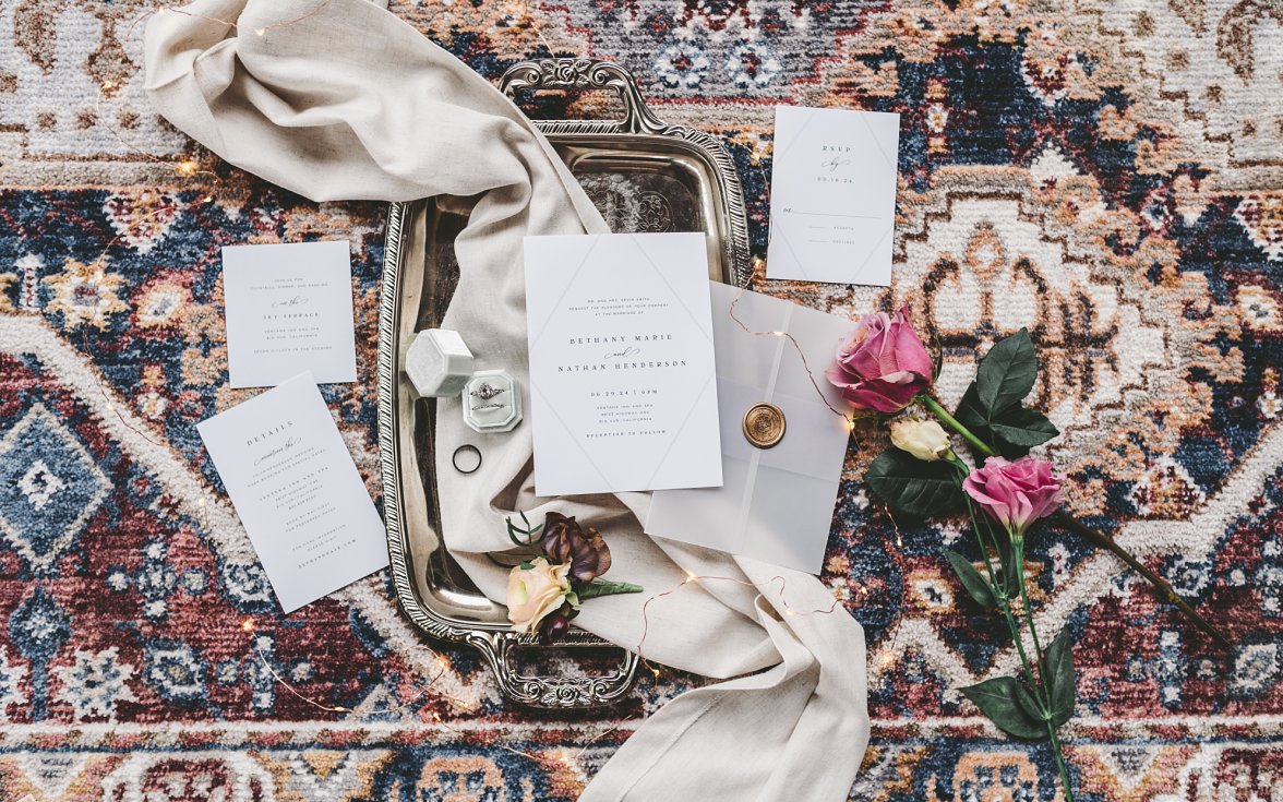 wedding flat lay of invitation, rings and flowers | Charlottesville Wedding Photographer