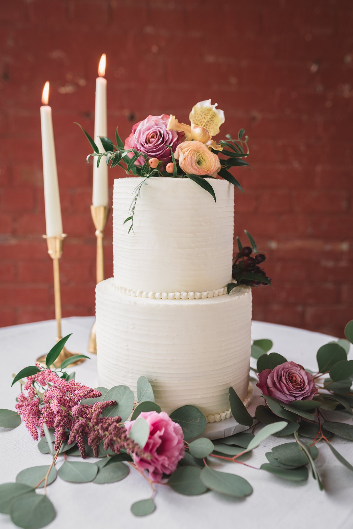 wedding cake with flowers and candles 