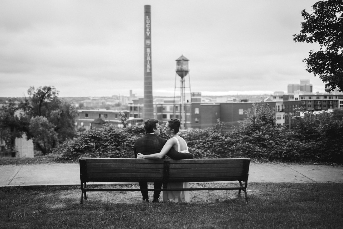 man and woman with arms around each other on bench at Libby hill Park | libby hill engagement session