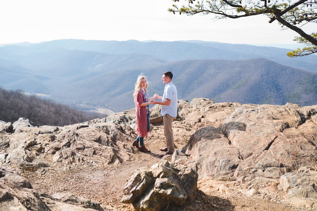 Couple holding hands on mountainside | Raven's Roost Engagement Session 