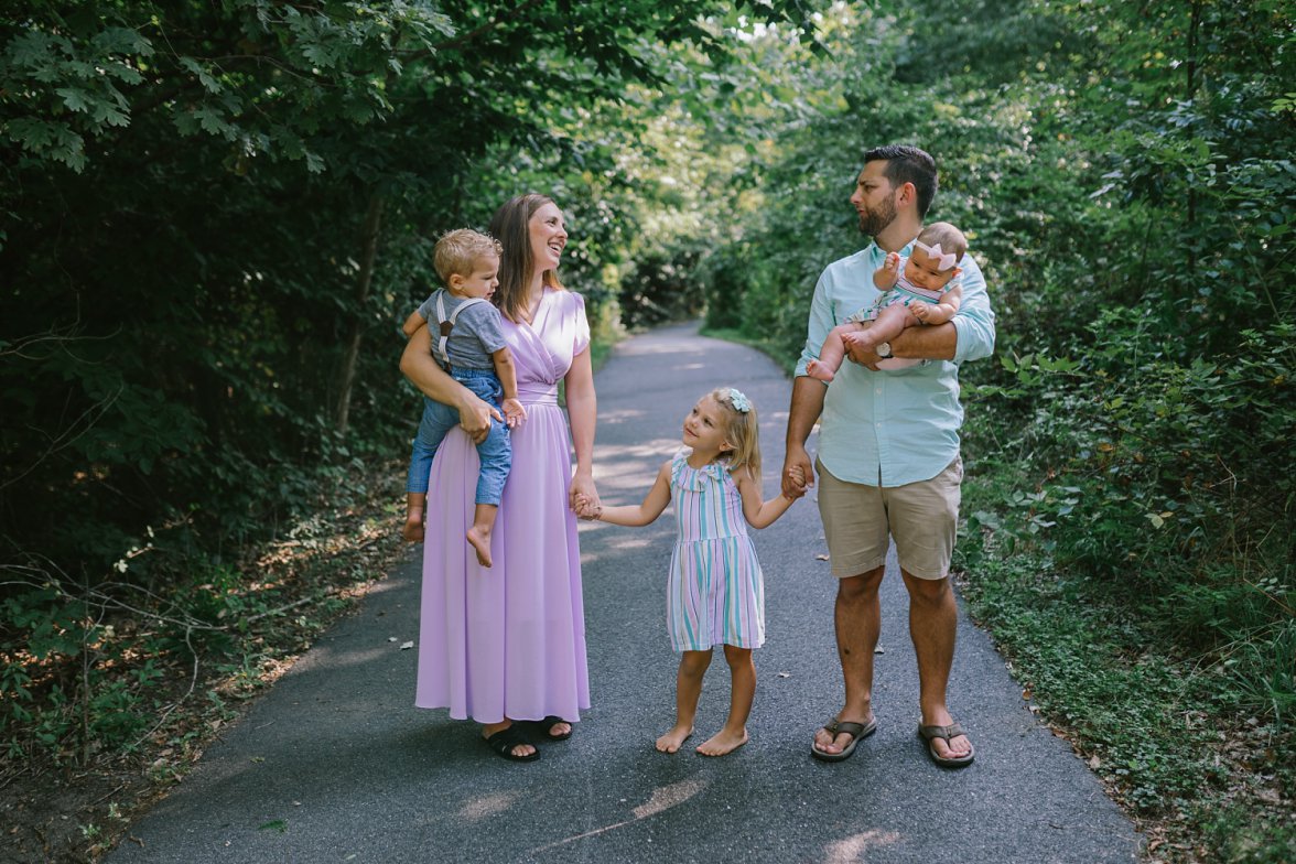 family of 5 standing together in green location | What To Wear for Family Photos
