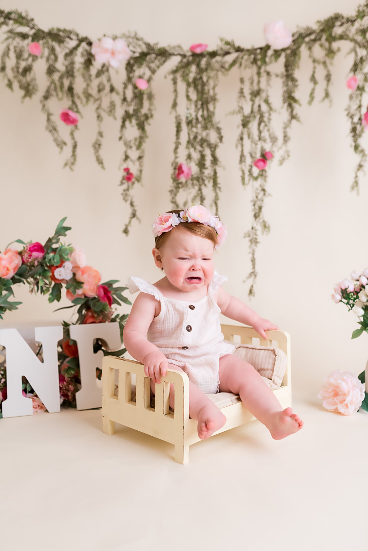 baby girl sitting on little bed crying | Dayton Baby Photographer