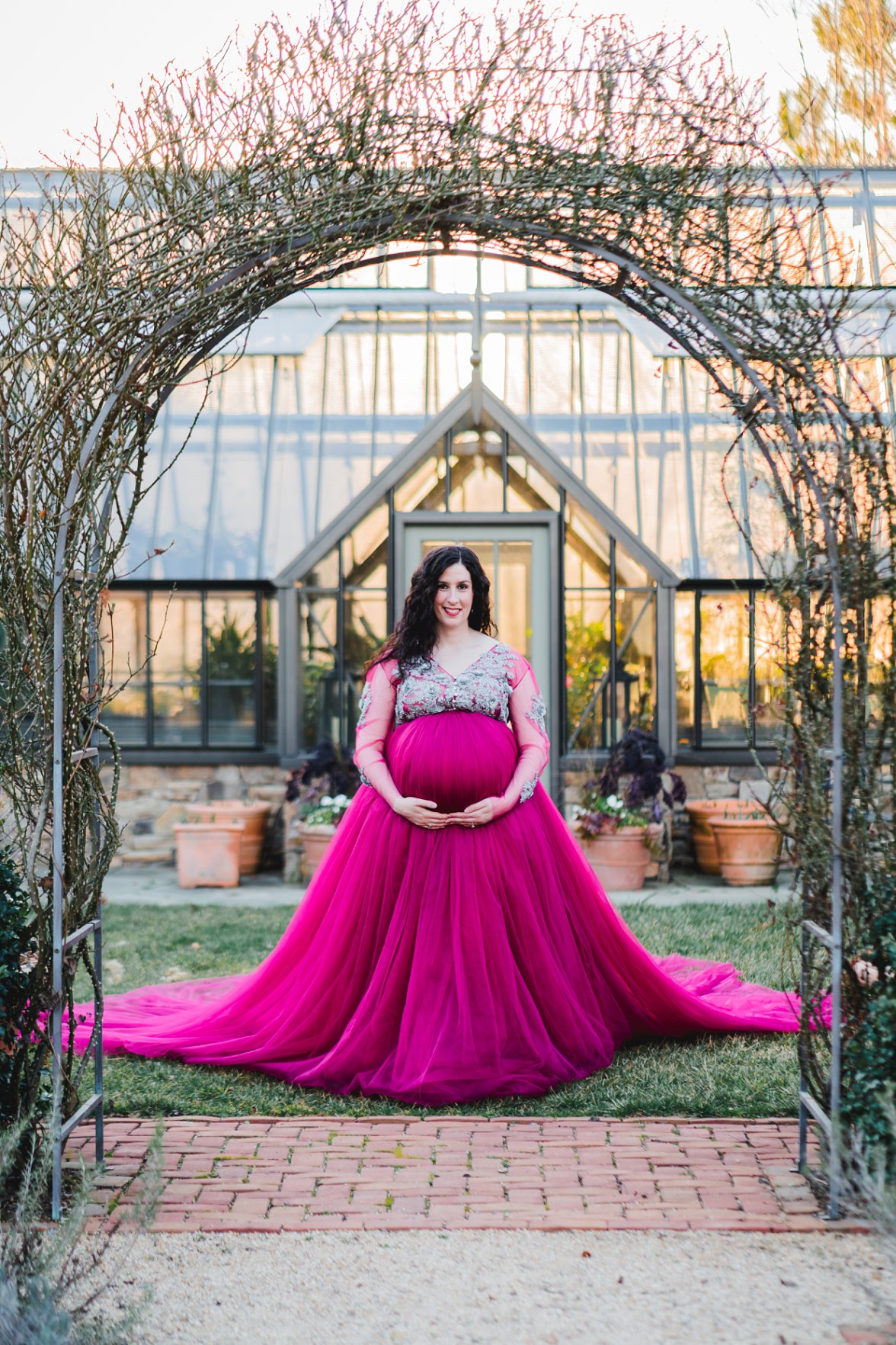Woman in maternity gown in a garden 