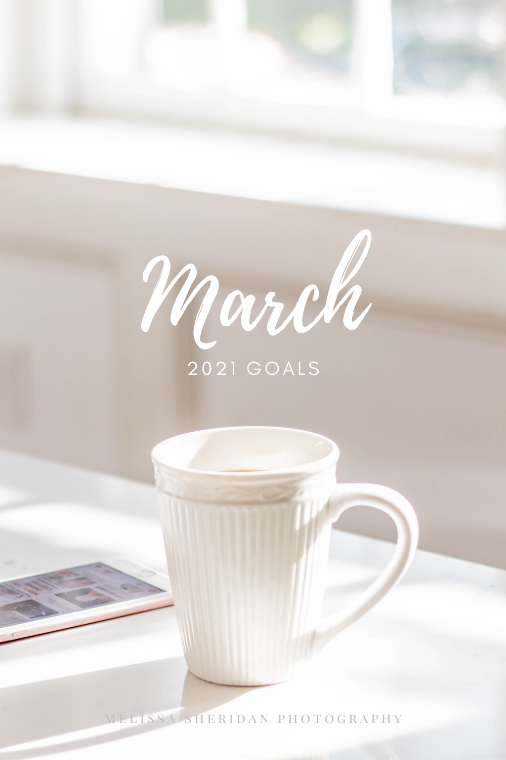 coffee cup and phone in a lit window | March 2021 Goals