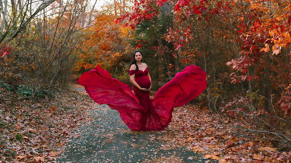 pregnant woman in red dress in fall foliage | Charlotteville Maternity Photography