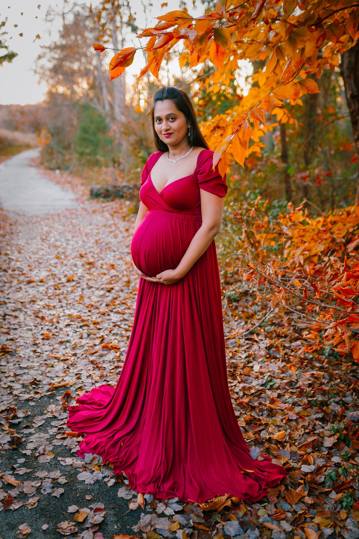pregnant mom in red dress in the fall | Charlotteville Maternity Photography