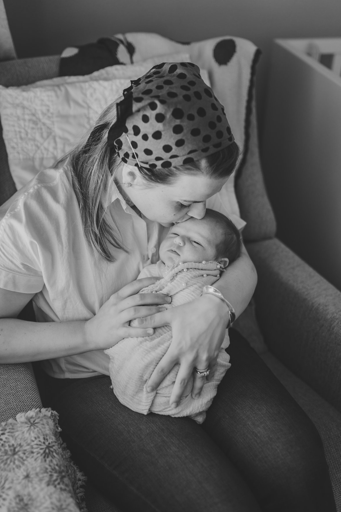 mom kissing baby girl's head | newborn lifestyle photography
