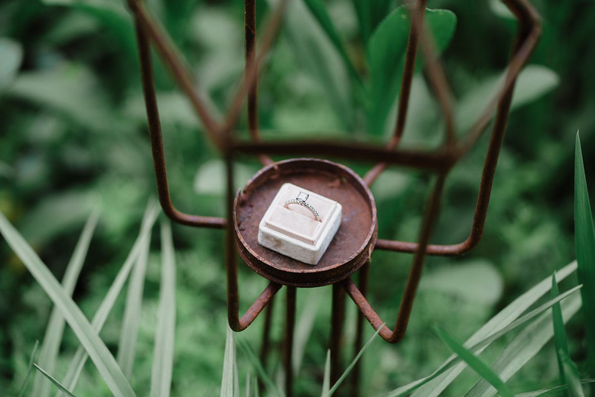 ring in ring box in iron metal garden thing | the mill at fine creek engagement