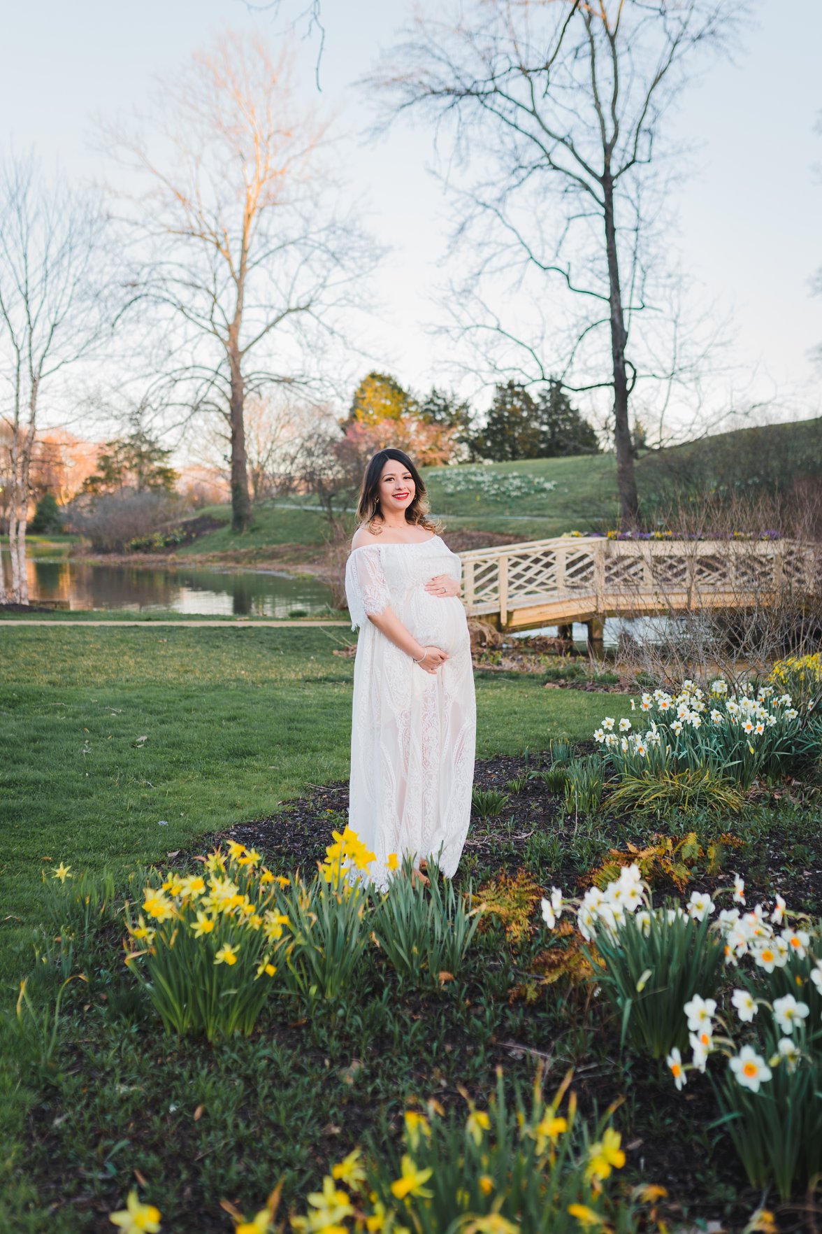 pregnant mom to be in white dress with flowers