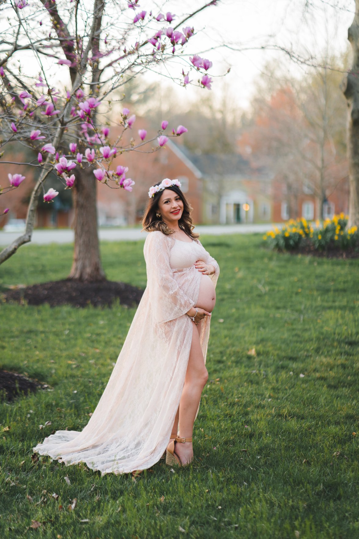 pregnant woman standing in flower blooms | maternity photographer dayton