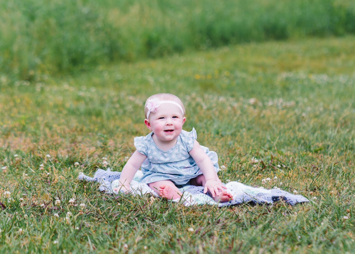 Baby girl sitting in a green field | Charlottesville Photographer