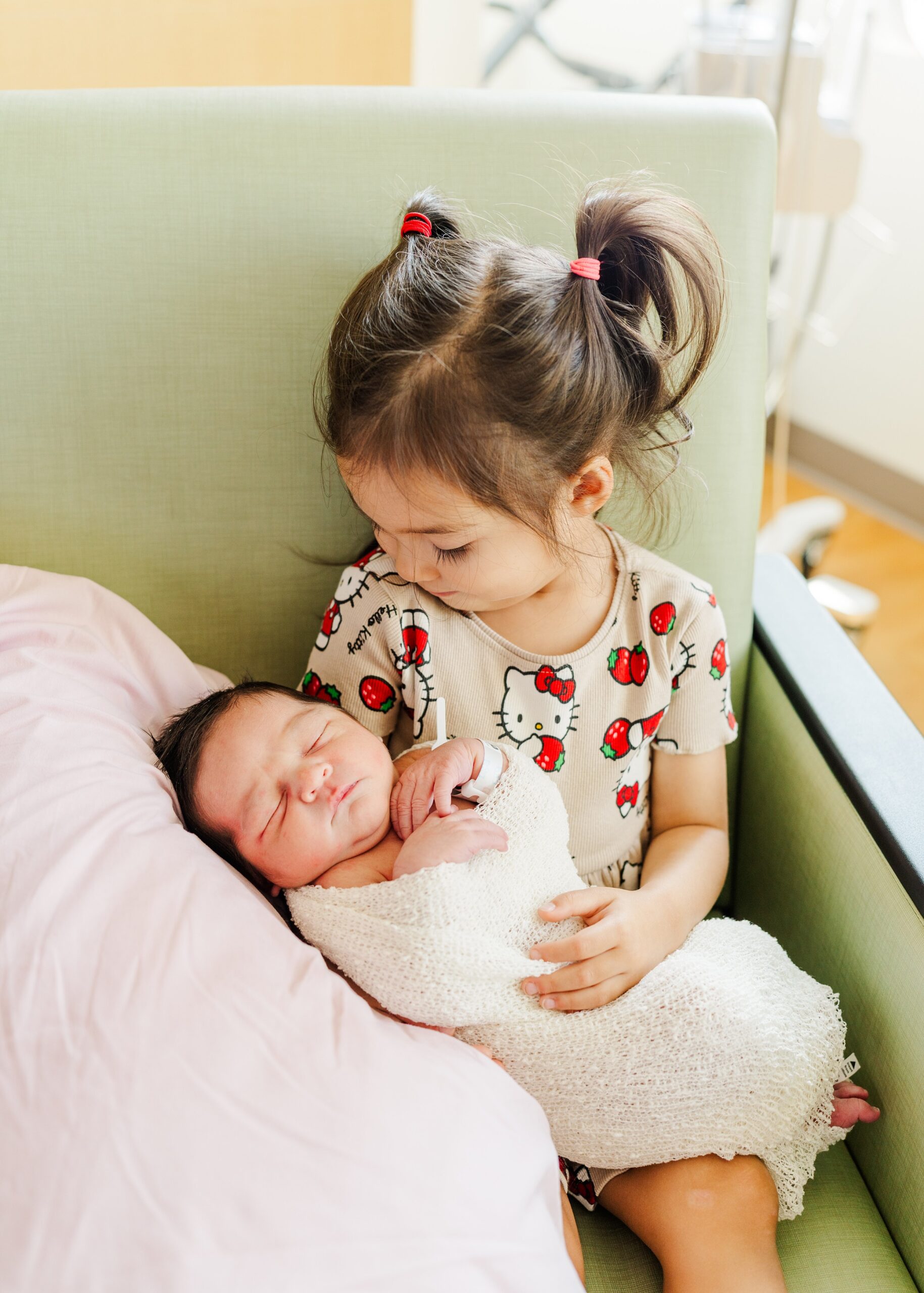 little girl holding new baby brother | fresh 48 photo session